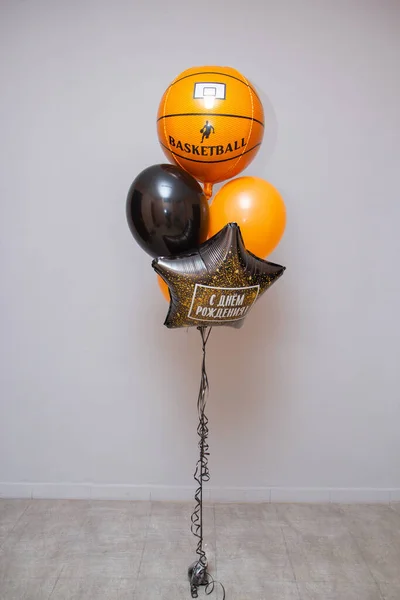 a set of orange balloons, a foil balloon basketball, the inscription on the balloon \