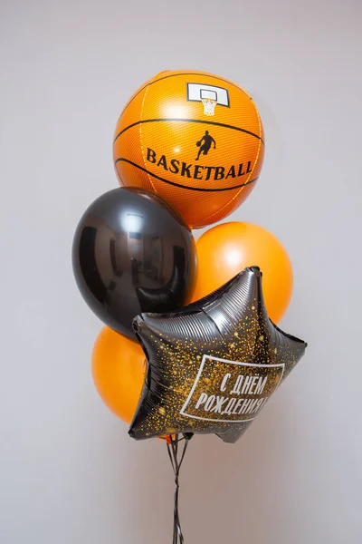 a set of orange balloons, a foil balloon basketball, the inscription on the balloon \