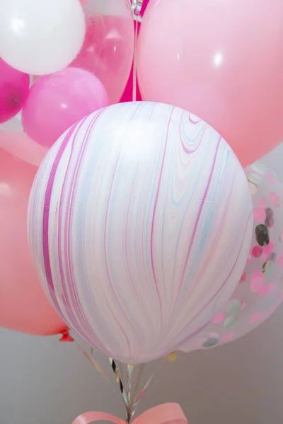 Set of pink balloons on wall background, helium balloon decor