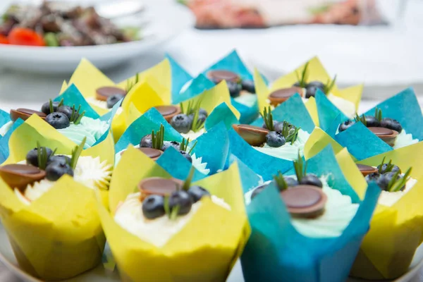 chocolate cupcakes in blue and yellow packaging