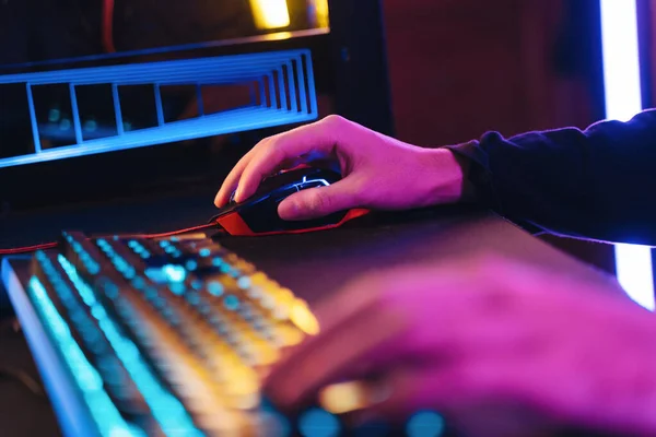 Close up of man gamers hands using professional computer mouse and keyboard for playing video game — Stockfoto