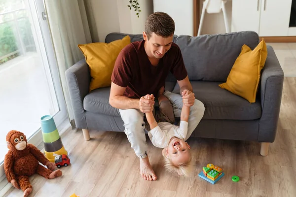 Young Dad Playing Active Games His Baby Boy Pulling His — Stock fotografie