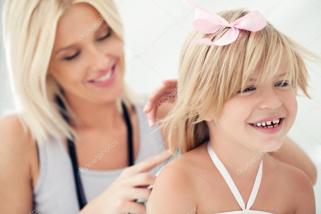 Mother Combing Daughter's Hair