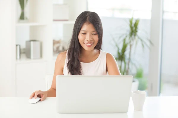 Asian Woman Surfing the Net at Home Royalty Free Stock Images