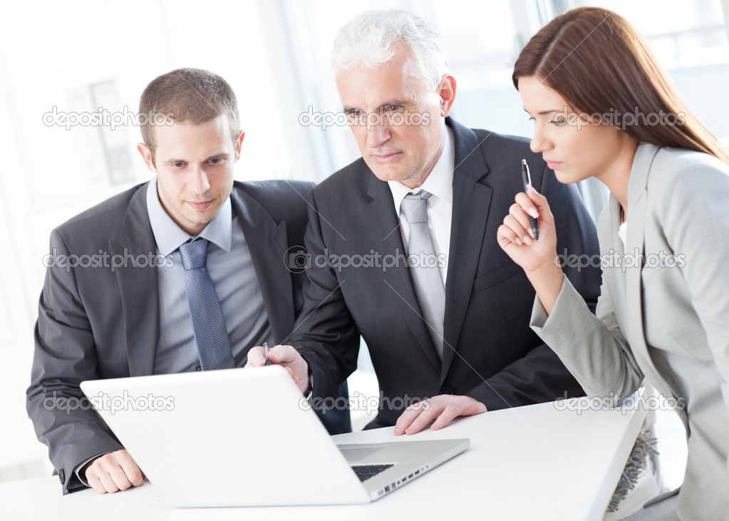 Businessman Showing Something to His Colleagues