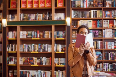 Woman Reading at a Book Shop clipart