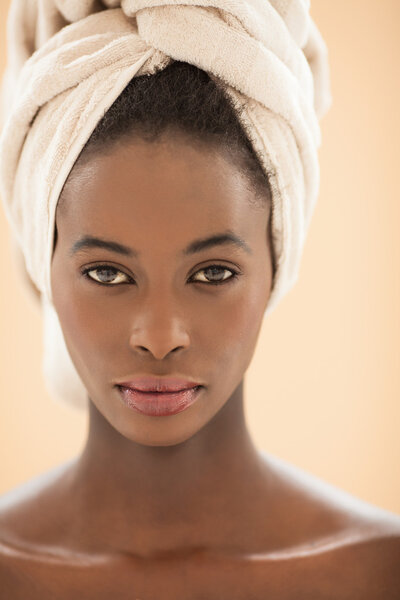 Portrait of a young African woman with a head towel.