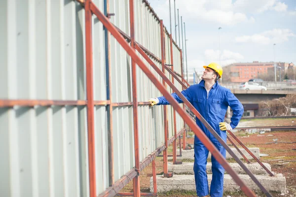 Builder Standing by a Metal Construction — Stock Photo, Image