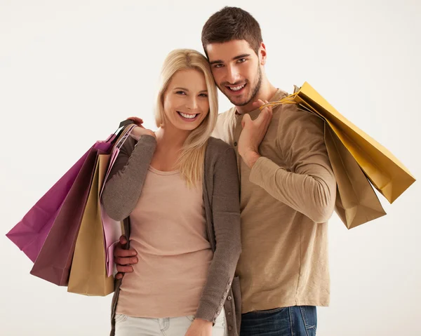 Smiling Couple Holding Shopping Bags Stock Photo