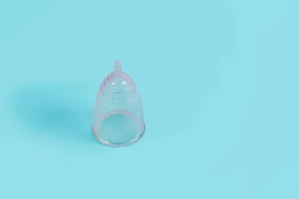 Eco-friendly menstrual cup on light blue background, space for text — Stock Photo, Image