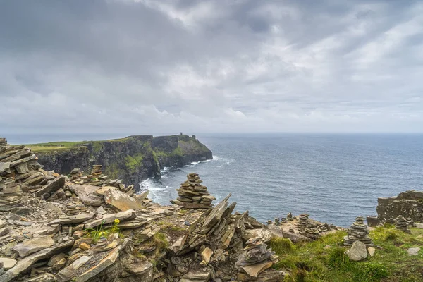 Rock balancing on the edge of iconic Cliffs of Moher, Ireland — стокове фото