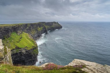 Iconic Cliffs of Moher with Moher Tower on far distance, Ireland