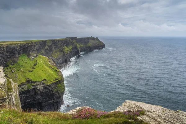 Iconic Cliffs of Moher with Moher Tower on far distance, Ireland — стокове фото