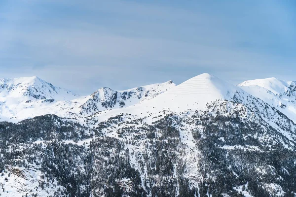 Snow capped mountain peaks of mountain range in Pyrenees Mountains. Winter ski holidays in El Tarter, Grandvalira, Andorra