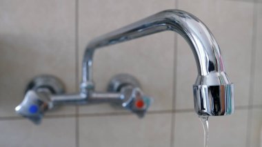Tap water dribbling. Waste of water resources