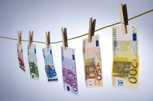 Euro cash notes hanging from a clothesline — Stock Photo, Image