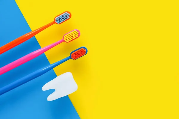 Three Bright Multi Colored Toothbrushes White Tooth Blue Yellow Background — Stock Photo, Image