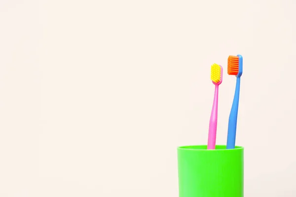 Two Multi Colored Toothbrushes Green Glass Copy Space — Stock Photo, Image