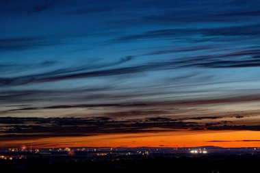 Fireworks speckly the horizon at sunset