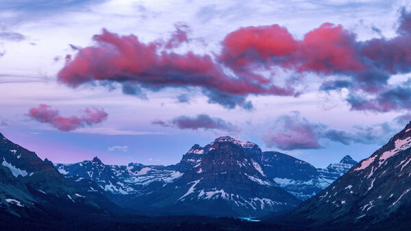 Morning paints fast moving clouds with warm colors