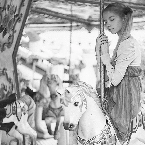 Girl posing on carousel