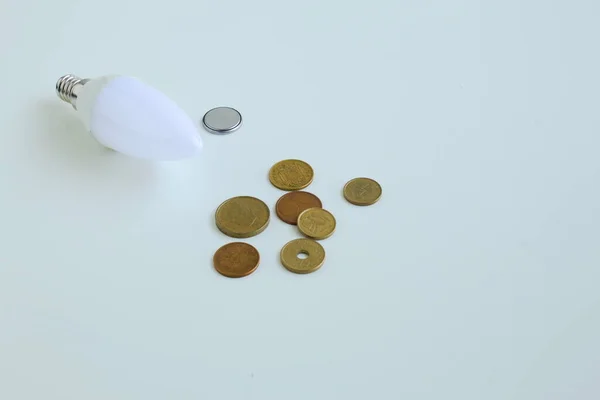 Set Batteries Coins Light Bulb White Background — Φωτογραφία Αρχείου