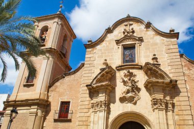 Nice facade with tower and bell tower of the church of Santa Eulalia in Murcia, in baroque style