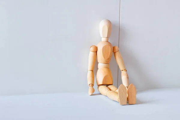 Concept of loneliness and abandonment with a wooden doll as a model