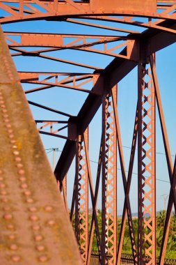 Metal structure of an old bridge with a useful design to support the weight of cars and trucks that cross the river