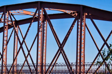 Metal structure of an old bridge with a useful design to support the weight of cars and trucks that cross the river