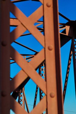 Metal structure of an old bridge with a useful design to support the weight of cars and trucks that cross the river