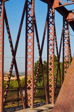 Metal structure of an old bridge with a useful design to support the weight of cars and trucks that cross the river
