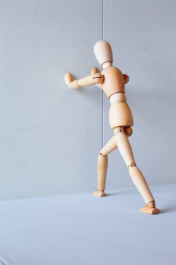 Wooden figure showing a position of stretching muscles to exercise