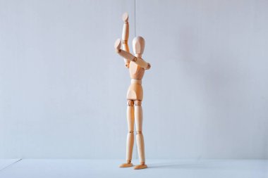 Concept of making the stop signal with the figure of a wooden boy