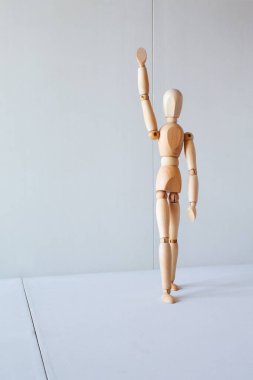 Greeting or leadership concept represented in a wooden doll