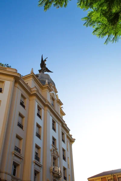 Nice building in Murcia with the Phoenix bird on the dome on a sunny day