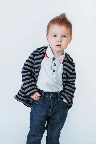 Little cute boy in a striped jacket standing and looking at the — Stock Photo, Image