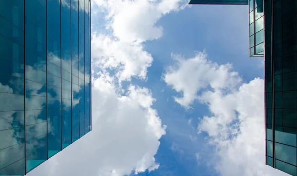 Rascacielos contra el cielo y la construcción de fondo de vidrio —  Fotos de Stock