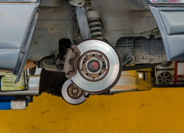 Car under repair on hoist at service station — Stock Photo, Image