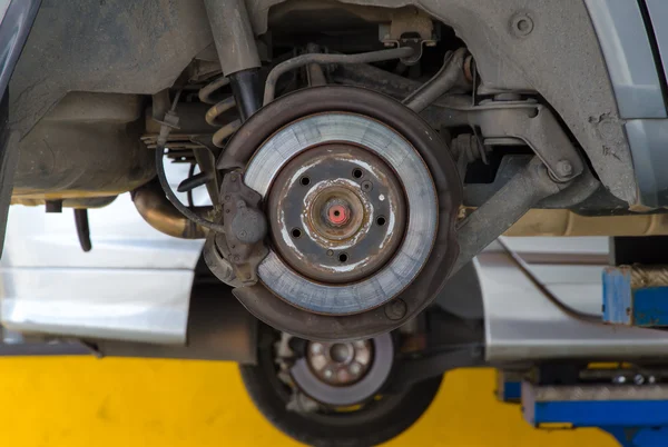 Car under repair on hoist at service station — Stock Photo, Image