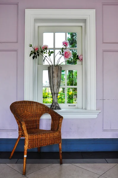 Rattan chairs with vase and window — Stock Photo, Image