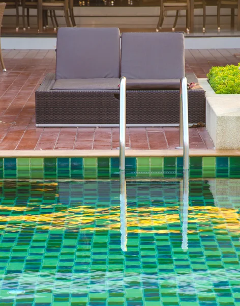 Beach chairs near swimming pool — Stock Photo, Image