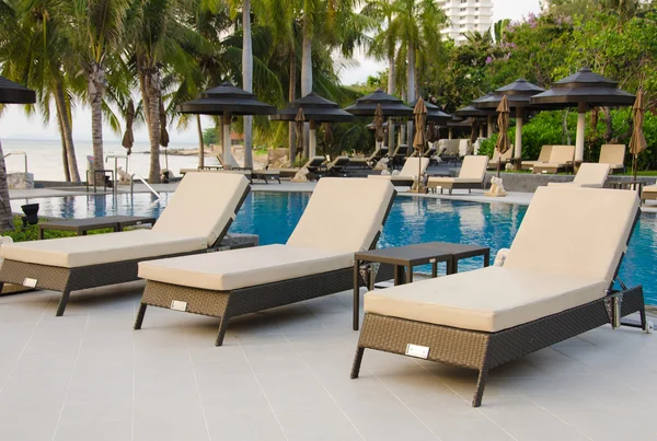 Beach chairs near swimming pool — Stock Photo, Image