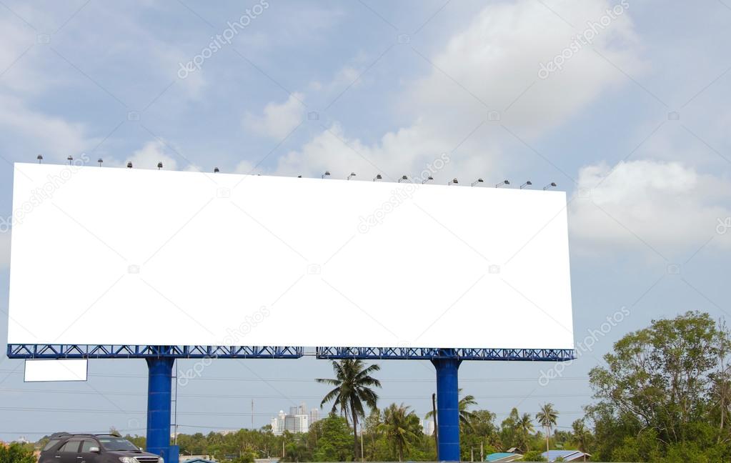 Large blank billboard on road with city view background