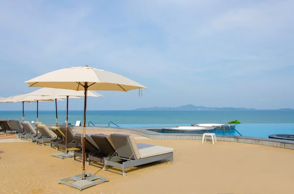 Beach chairs near swimming pool — Stock Photo, Image