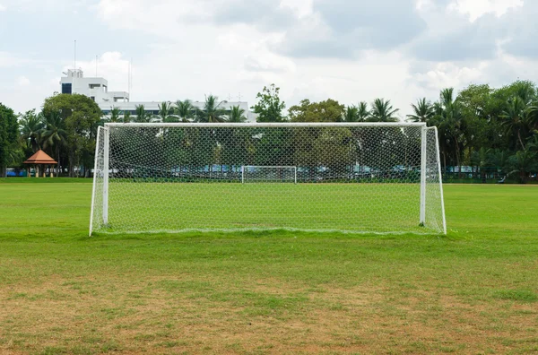 Voetbal doel aan het eind van een leeg veld op een park — Stockfoto