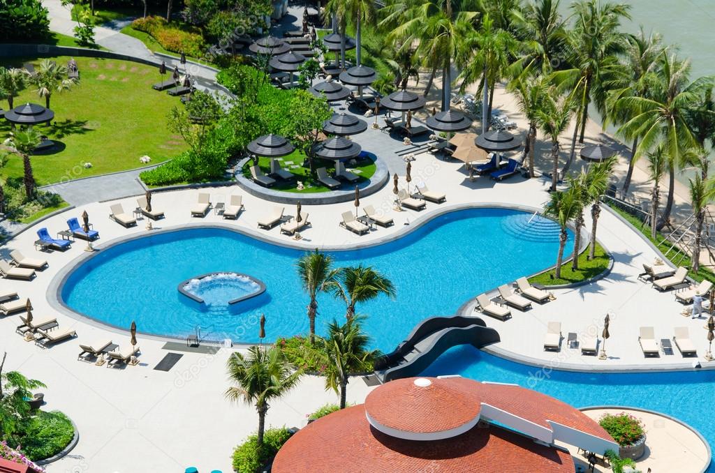 Top view of Swimming pools at tropical beach in luxury hotel