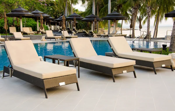 Beach chairs near swimming pool — Stock Photo, Image