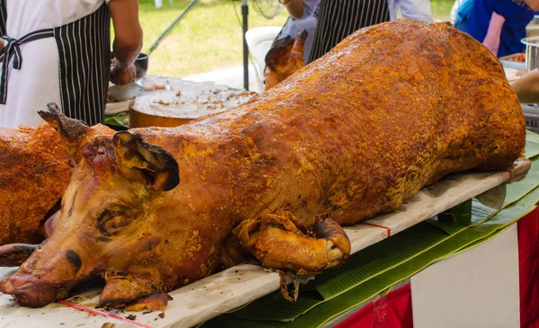 Grilled whole roasted pig Spit roasting is a traditional