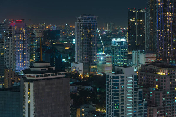 Landscape of Contemporary Architecture Office Building in Bangkok cityscape in night time.